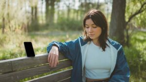 Digital Detox: Person Turning Off Phone in Nature